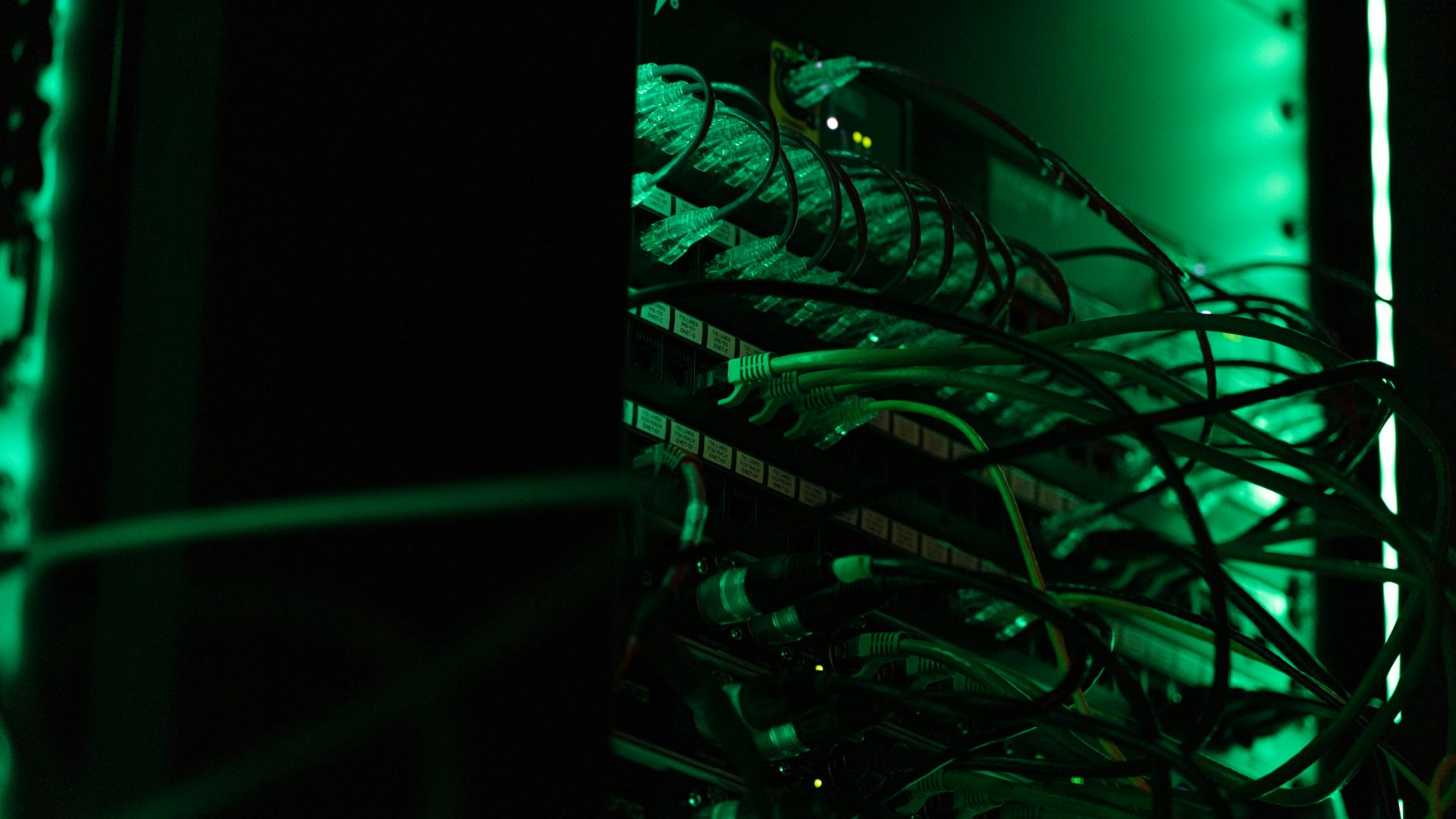 Network server rack with patched cabling under green light